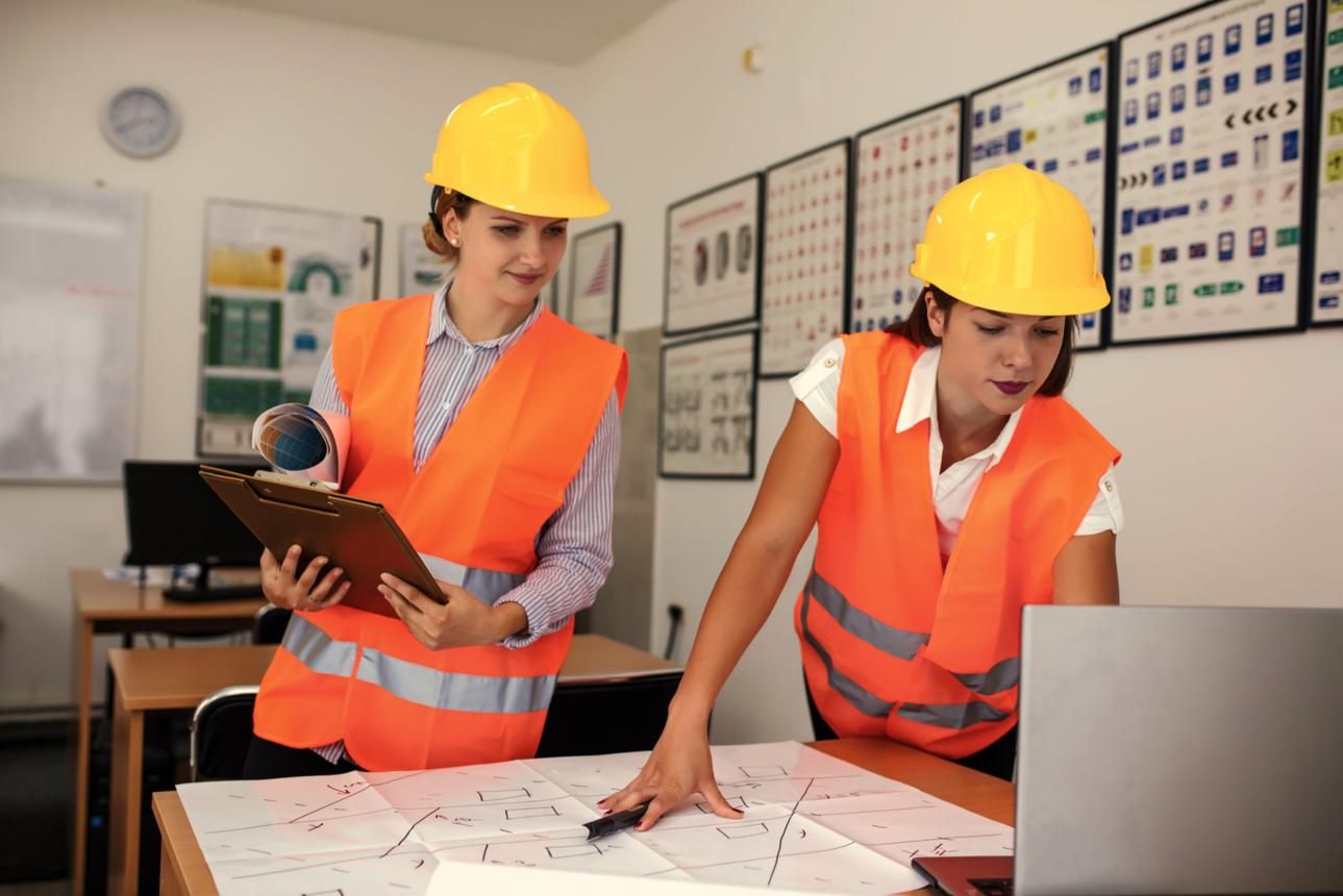 Engineers planning a project with drawings in the office