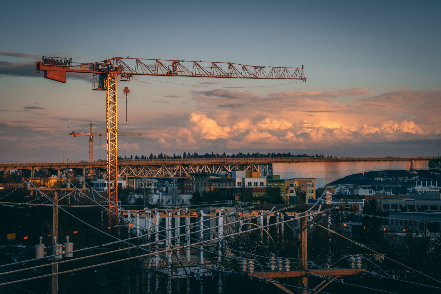 Tower crane above a London construction site at sunset